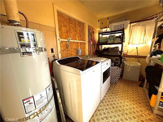 laundry area featuring water heater and washer and dryer