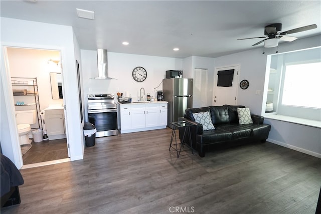 living room featuring ceiling fan, dark wood-type flooring, and sink