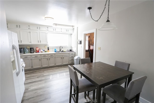 dining space featuring light hardwood / wood-style flooring and sink