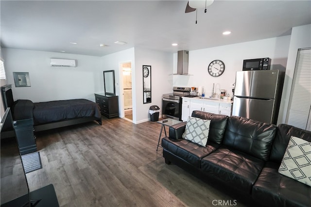 living room with ceiling fan, hardwood / wood-style flooring, sink, and a wall mounted AC