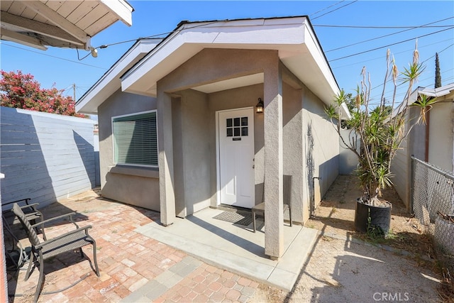 doorway to property featuring a patio