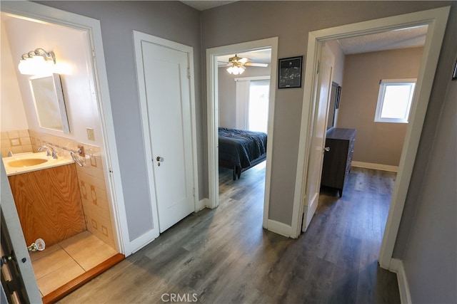 hallway featuring dark hardwood / wood-style floors and sink