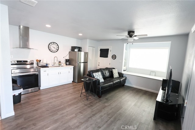 living room with ceiling fan, sink, and dark hardwood / wood-style flooring