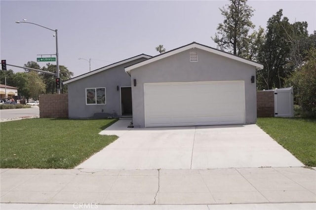 ranch-style home featuring a garage and a front lawn