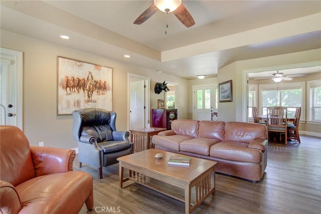 living room with plenty of natural light, dark hardwood / wood-style floors, and ceiling fan