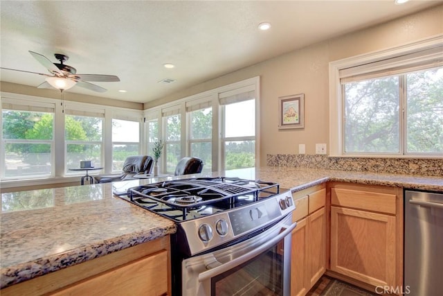 kitchen with ceiling fan, stainless steel appliances, and light brown cabinets