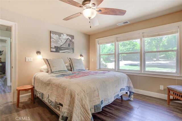 bedroom with ceiling fan and dark hardwood / wood-style flooring