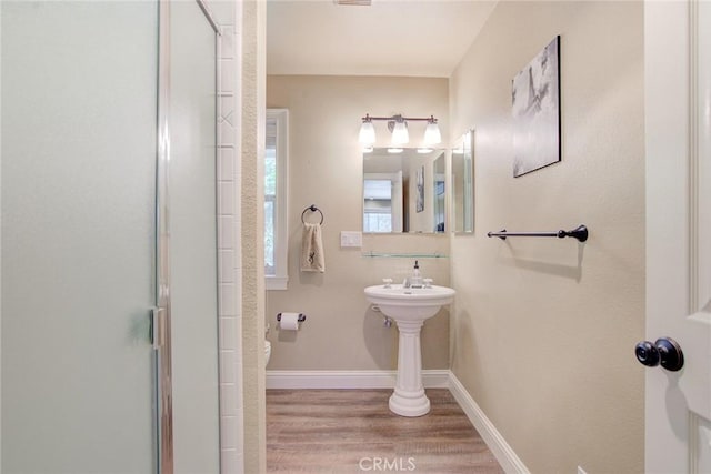 bathroom with walk in shower and hardwood / wood-style floors