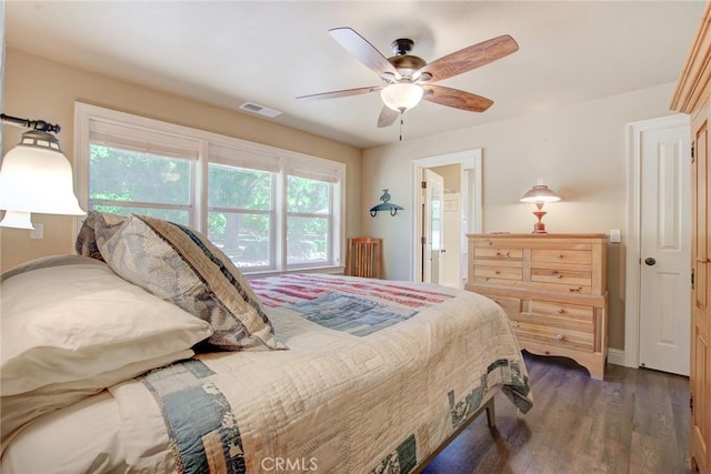 bedroom with ceiling fan, connected bathroom, and dark hardwood / wood-style floors