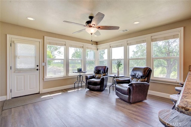 sitting room with hardwood / wood-style flooring, a wealth of natural light, and ceiling fan