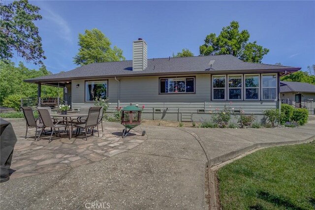 rear view of property featuring a patio area