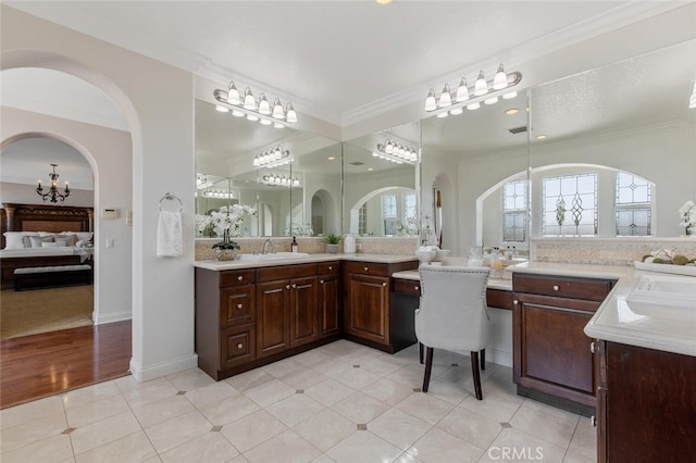 bathroom featuring vanity, crown molding, and tile patterned floors