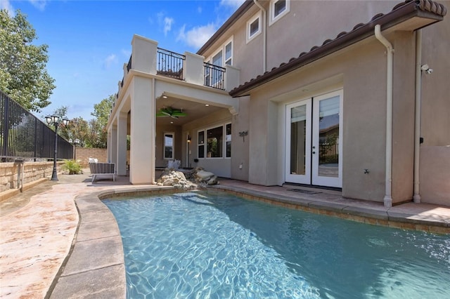 view of swimming pool featuring french doors and a patio