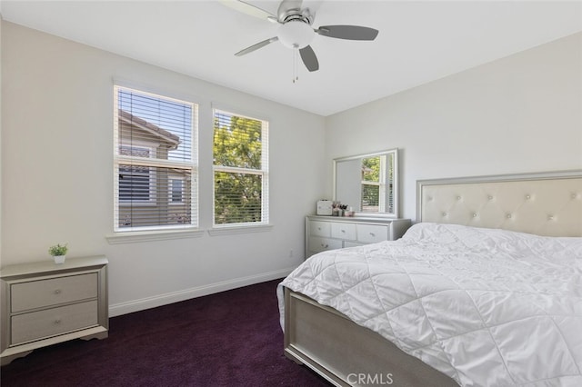 carpeted bedroom featuring multiple windows and ceiling fan