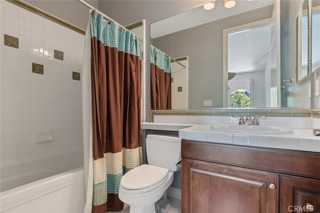 full bathroom featuring toilet, vanity, and shower / bathtub combination with curtain