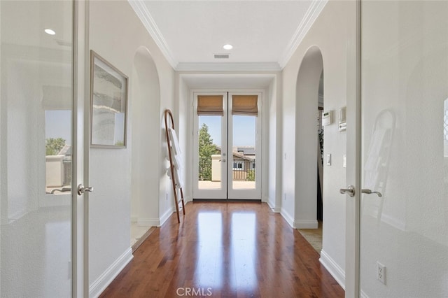 doorway to outside featuring hardwood / wood-style flooring, ornamental molding, and french doors