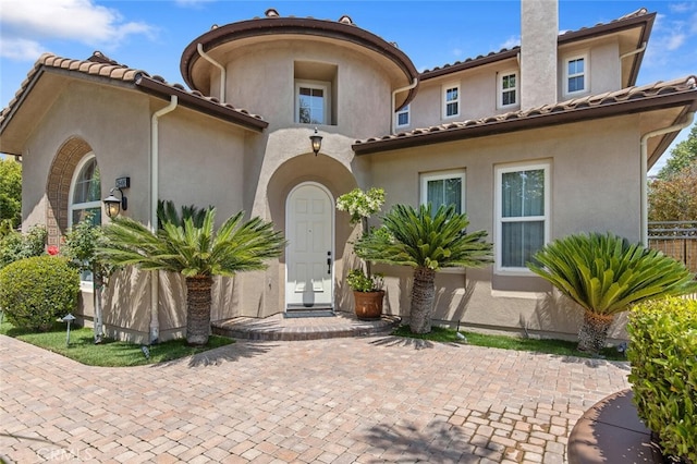 mediterranean / spanish-style home with a patio