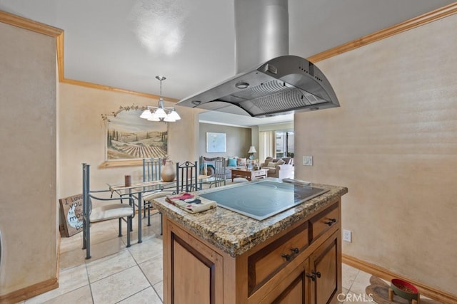 kitchen featuring island exhaust hood, cooktop, crown molding, light tile patterned floors, and hanging light fixtures