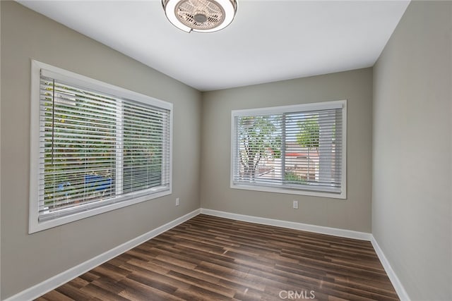 spare room featuring dark wood-type flooring