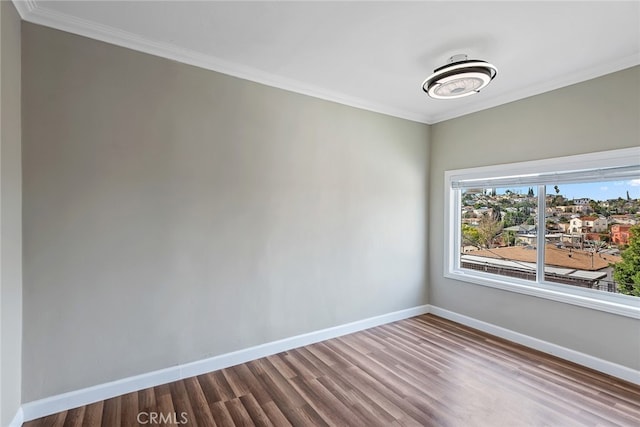 unfurnished room featuring crown molding and hardwood / wood-style floors