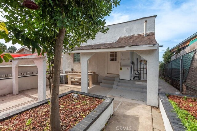 back of property with a patio area