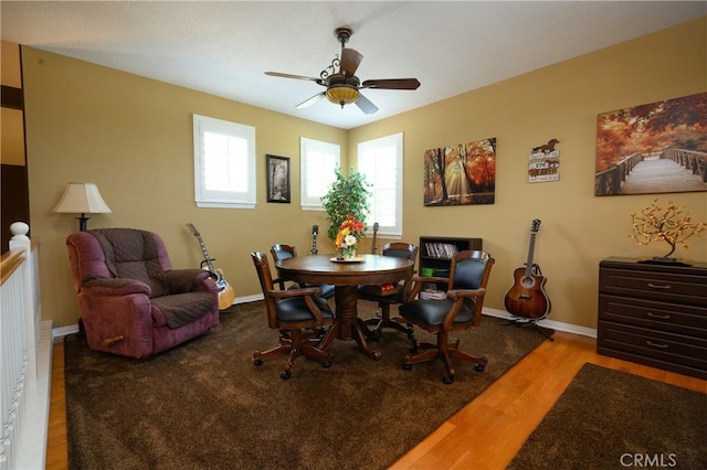 dining space with hardwood / wood-style flooring and ceiling fan