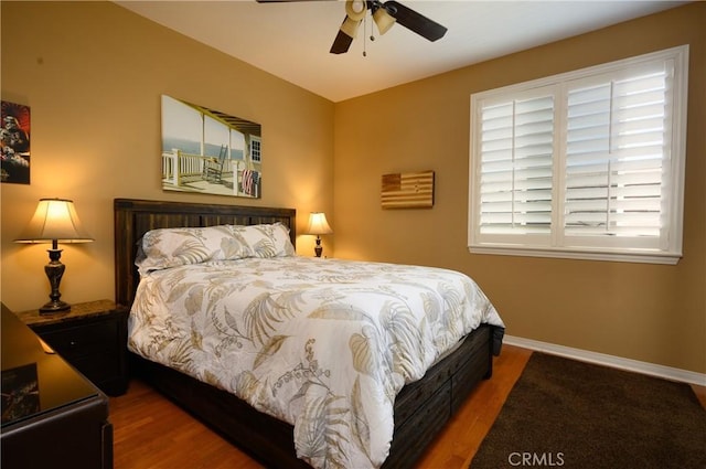 bedroom with ceiling fan and wood-type flooring