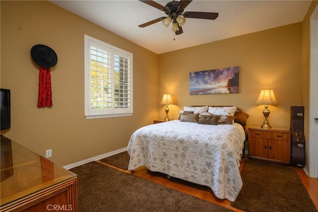 bedroom featuring dark colored carpet and ceiling fan