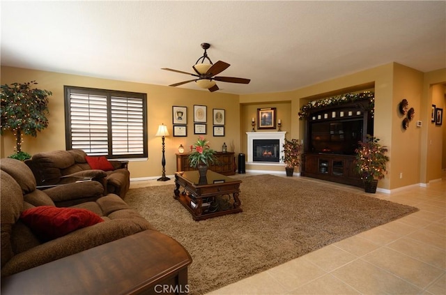 living room with ceiling fan and light tile patterned flooring