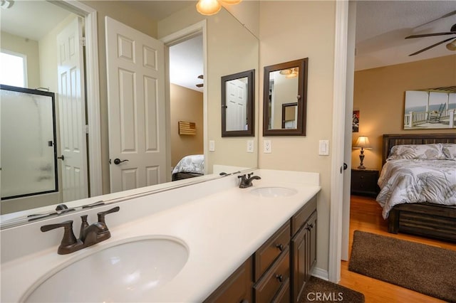 bathroom featuring vanity, ceiling fan, and wood-type flooring