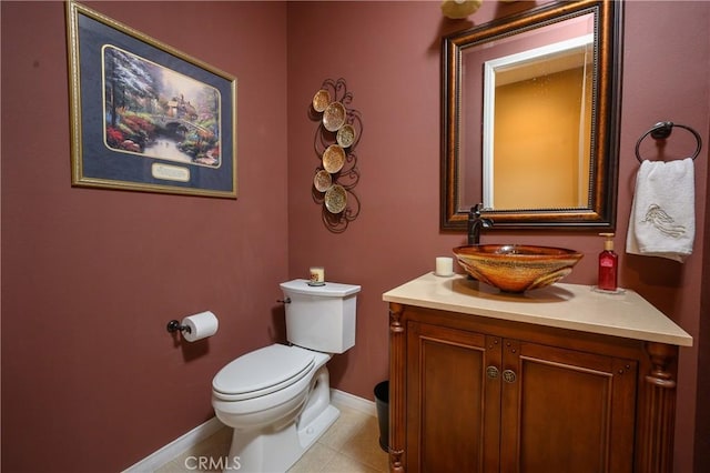 bathroom featuring toilet, vanity, and tile patterned floors