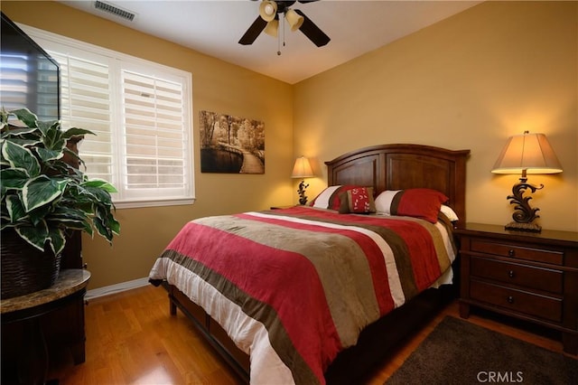 bedroom featuring ceiling fan and hardwood / wood-style floors