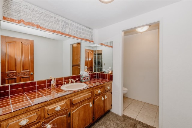 bathroom featuring toilet, tile patterned flooring, and vanity