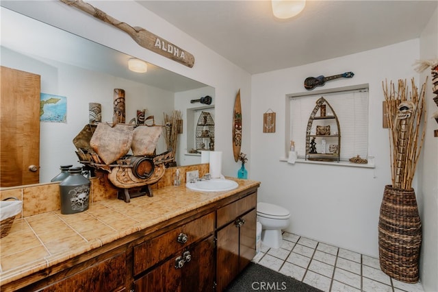 bathroom with tile patterned floors, vanity, and toilet