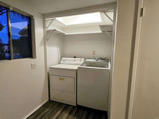 laundry room with dark hardwood / wood-style flooring and washing machine and clothes dryer