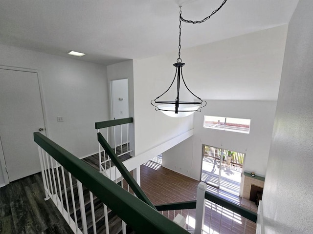 stairs featuring a high ceiling and hardwood / wood-style floors