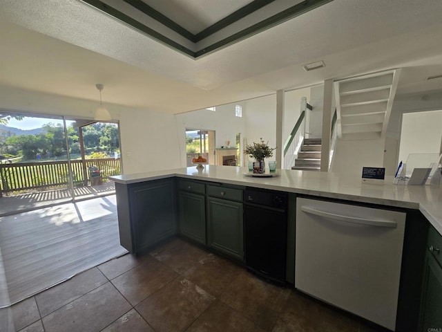 kitchen with decorative light fixtures, dark tile patterned floors, kitchen peninsula, and stainless steel dishwasher