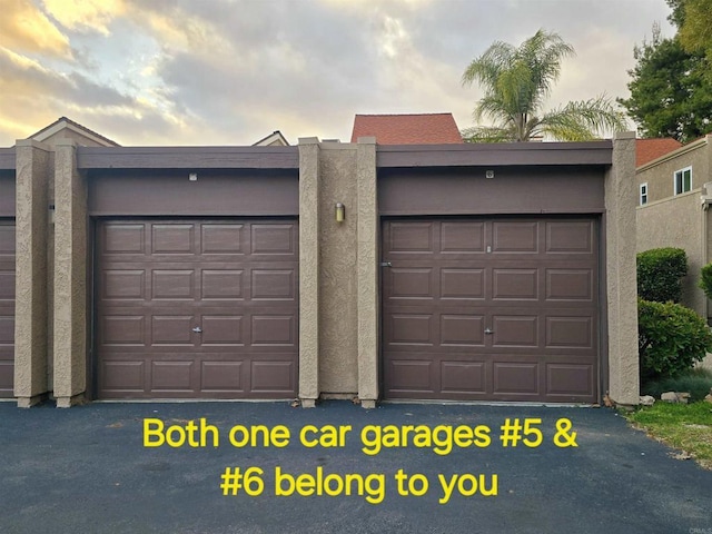 view of garage at dusk