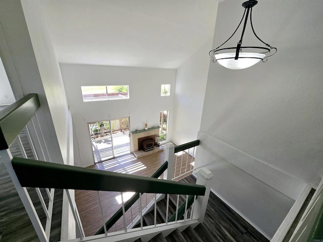 stairway featuring a towering ceiling