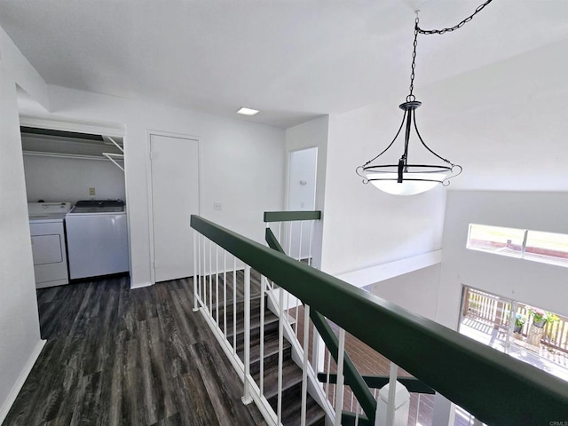 corridor with dark hardwood / wood-style floors and washing machine and clothes dryer