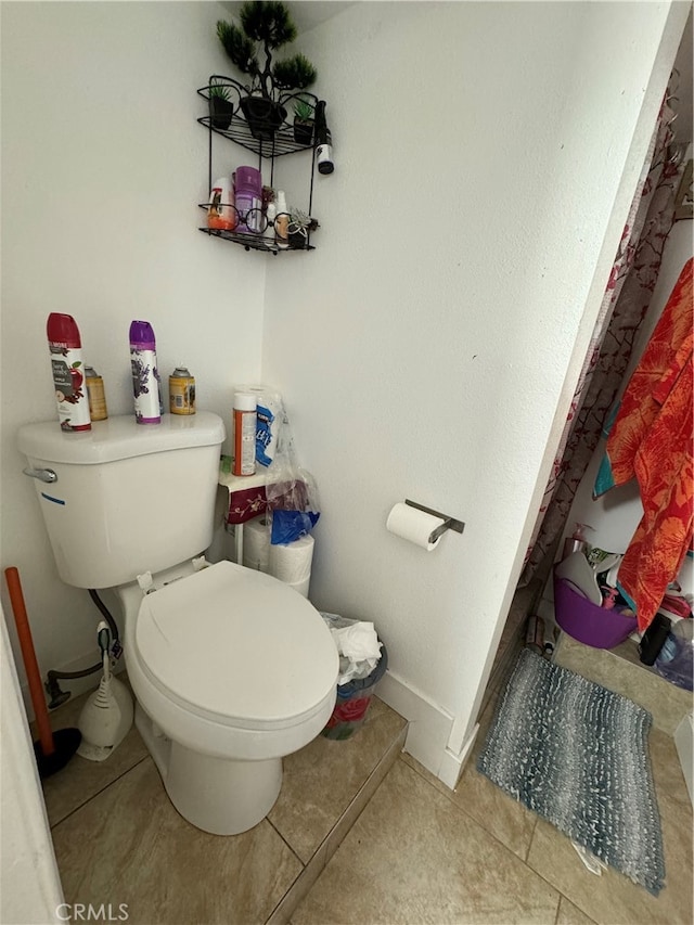 bathroom with tile flooring and toilet