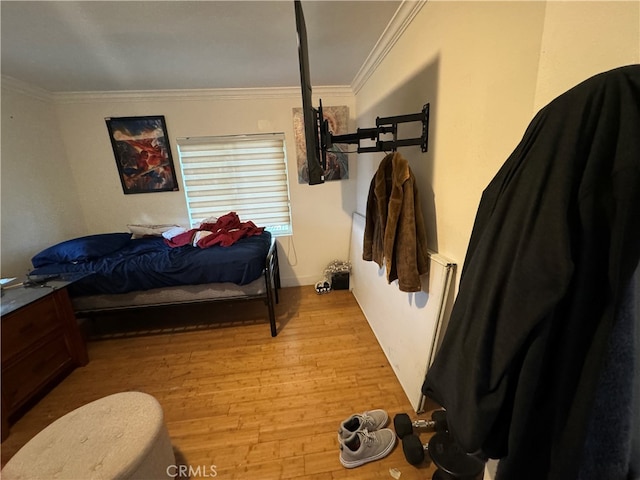 bedroom featuring crown molding and hardwood / wood-style floors