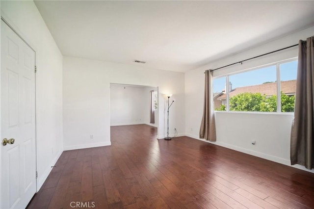 empty room with dark hardwood / wood-style floors