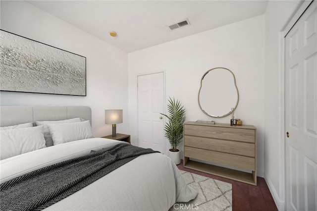 bedroom with wood-type flooring and a closet