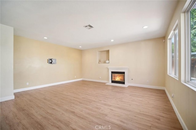 unfurnished living room featuring light hardwood / wood-style flooring