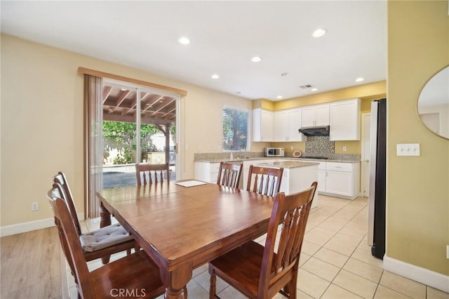 tiled dining space featuring sink