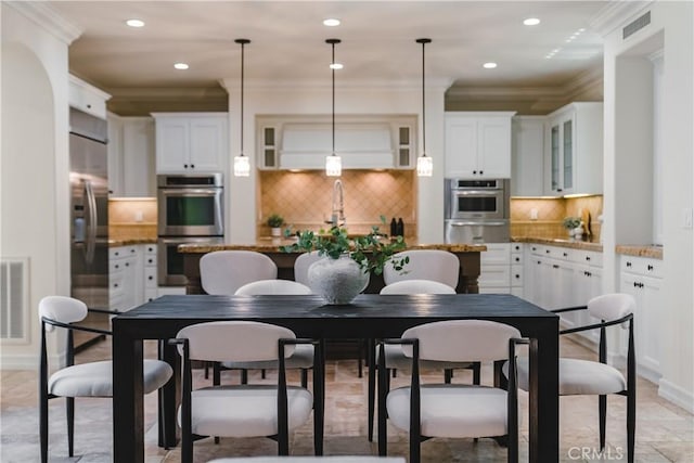 dining room with baseboards, recessed lighting, visible vents, and ornamental molding