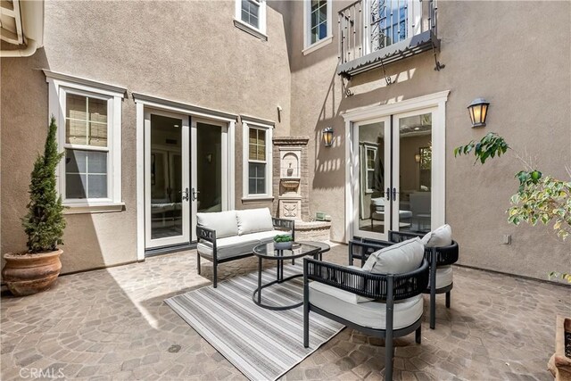 view of patio with an outdoor living space and french doors