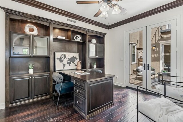 office area with ornamental molding, built in desk, dark wood-type flooring, and french doors