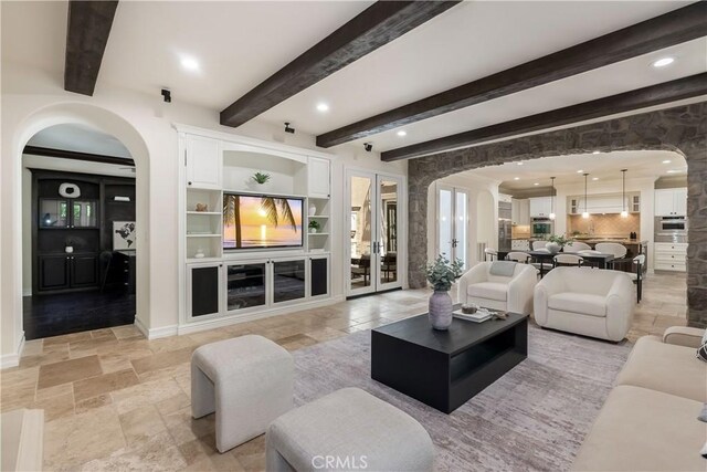 living room featuring beamed ceiling